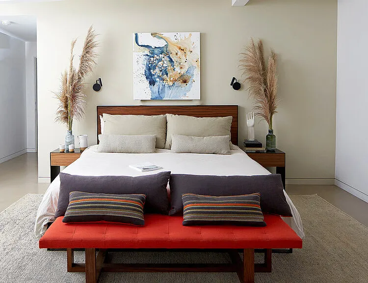 Peaceful primary suite with plush king bed, sitting area & large walk in closet