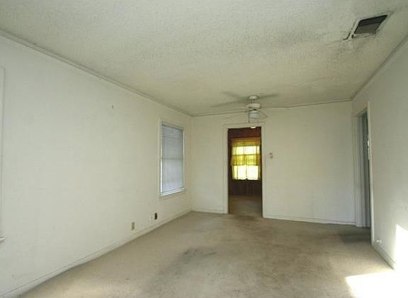 the living room is long and opens to the kitchen and hallway.