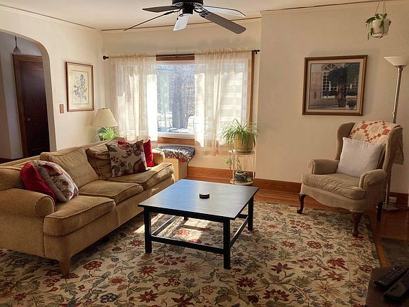 Living room connecting to hallway and dining room.