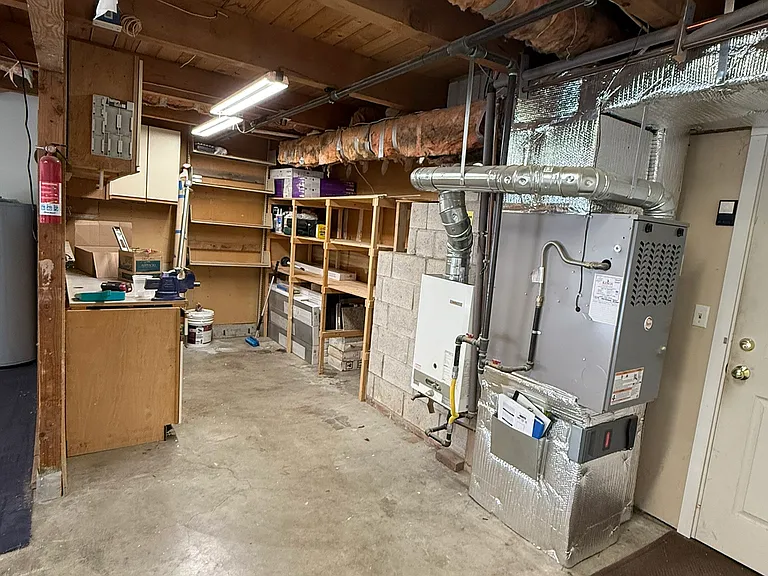 Work area in the back of the garage. Great for storing tools with cabinets for storage and a counter to serve as a work area