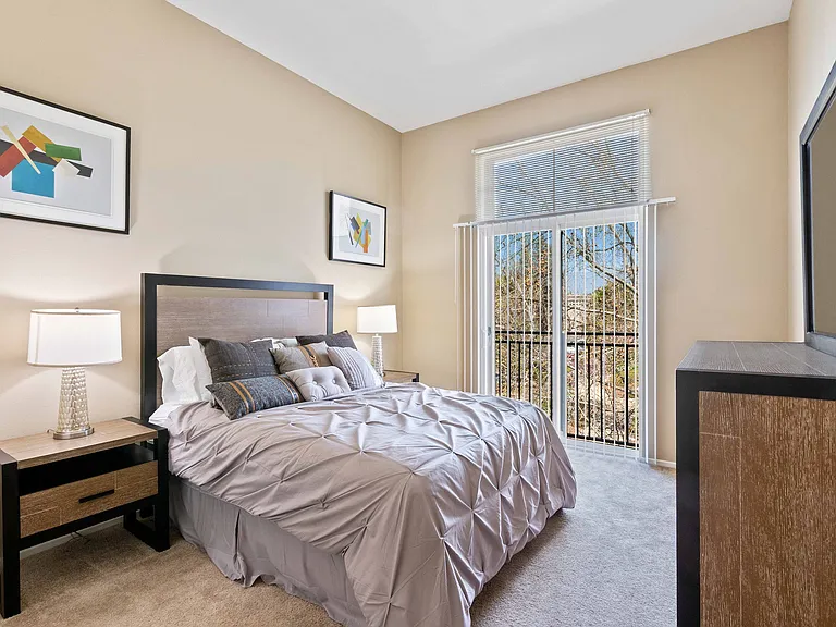 Cozy bedroom with scenic window view.