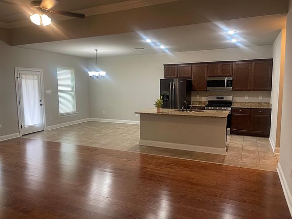 Kitchen, dining room, back door to patio & fenced yard