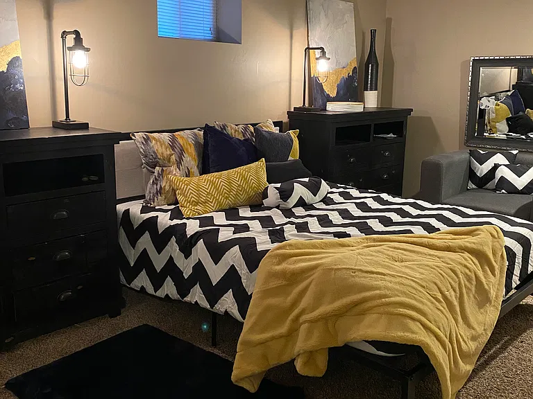 Basement bedroom with full bathroom/ laundry room in adjacent room.
