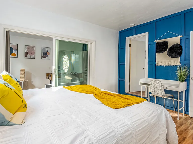 Thoughtfully arranged decor and airy design lead seamlessly to a private ensuite bathroom.