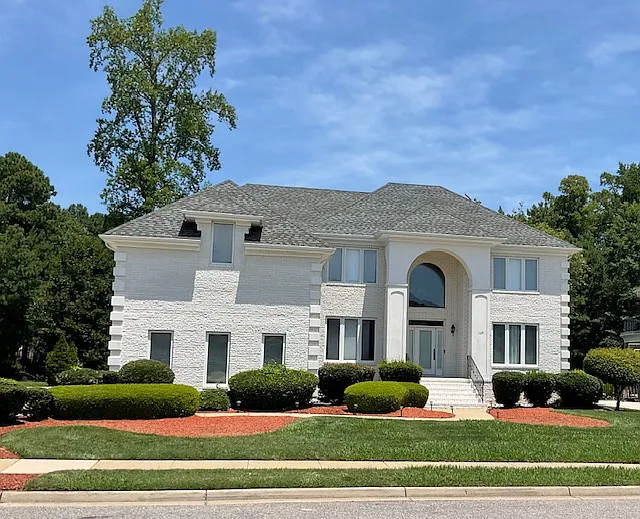 Don't miss this "white-house"!! All white-brick home with hip-roof, beautiful landscaping, 3-car garage, brick & concrete patio and large backyard with trees, pond and working fountain.