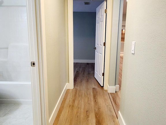 Hallway between 2nd, 3rd bedroom and 2nd bathroom in between.