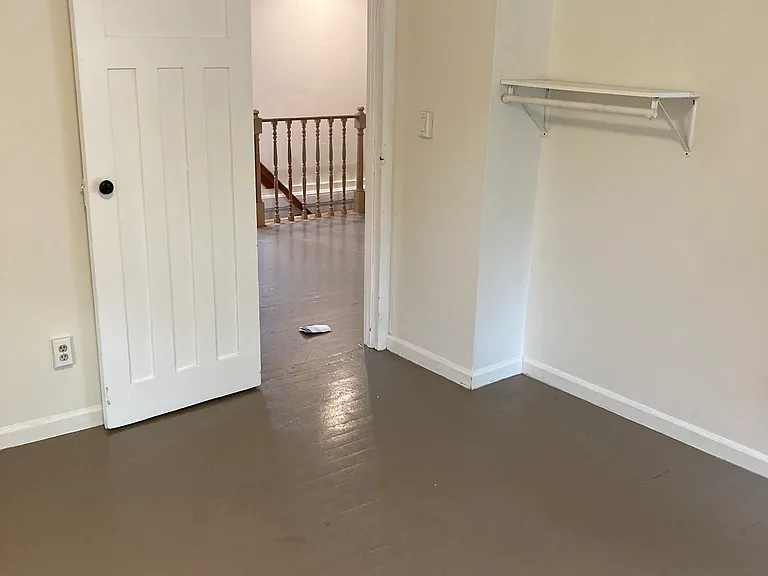 Southeast bedroom showing doorway to den and stairway