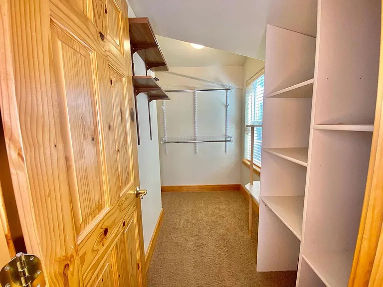 large walk in closet with built in shelves
