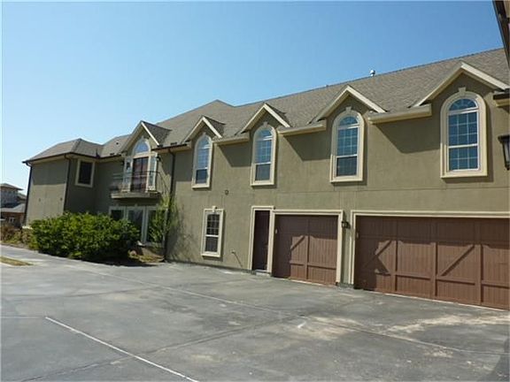 Right side of the home - There are 5 garages. 2 single - one with built-ins and a sink, plus a large 3 car garage with 1 double and 1 single door