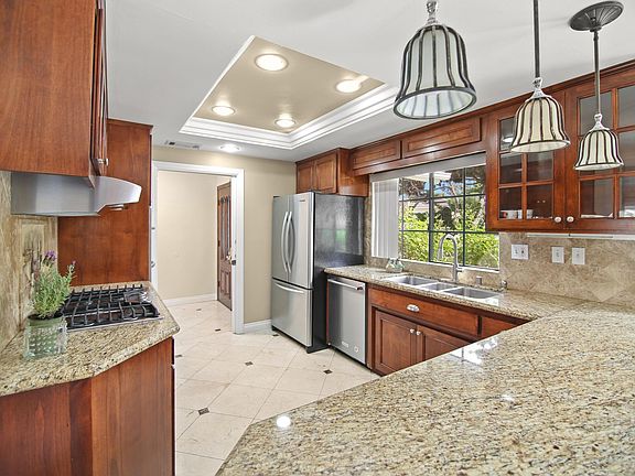 Chef's kitchen with ample counter space and stainless steel appliances.
