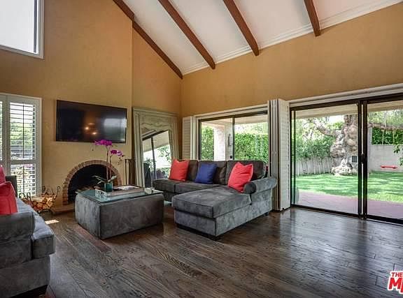 Large living room with half vaulted ceiling.