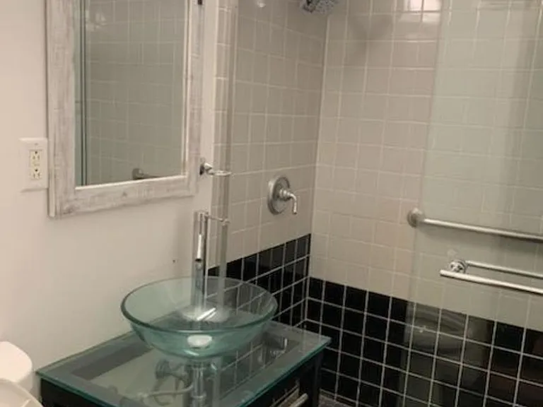 raised glass sink bowl. high neck faucet. granite floor, extra large shower (possible wifi shower head)