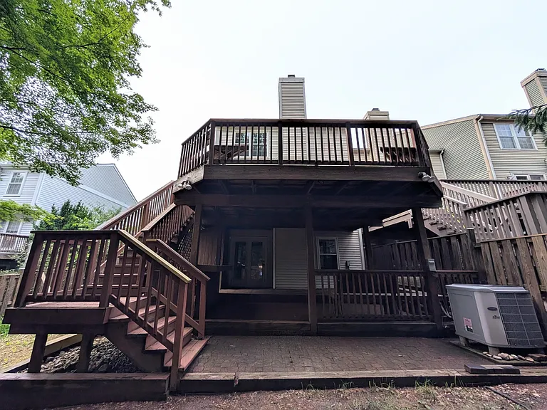 Two-level deck in fenced in yard