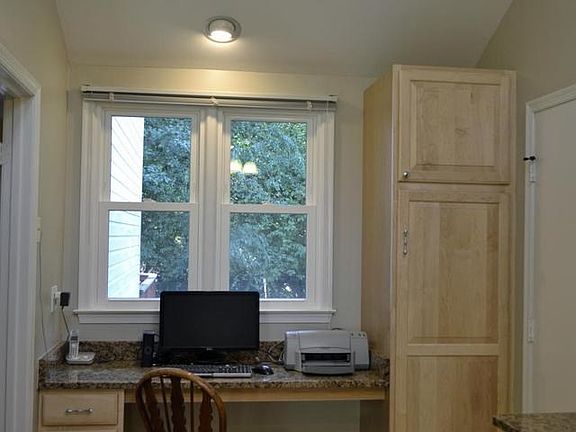 Kitchen desk area overlooks rear yard