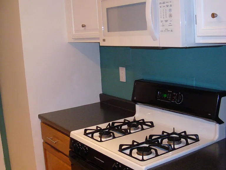 Kitchen gas range and LG microwave oven.