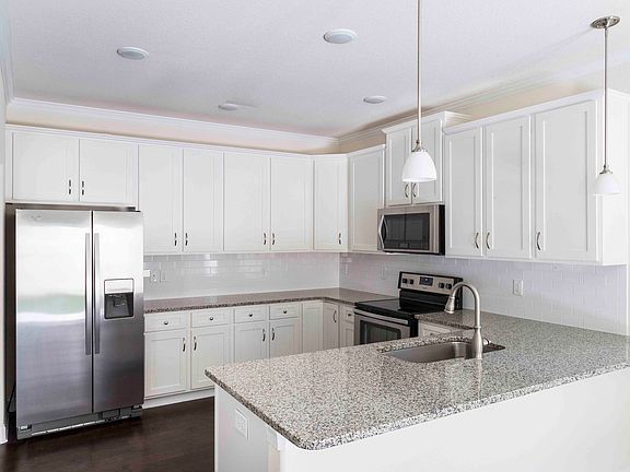 Granite countertops, tiled back splash and upgraded lighting fixtures are standard