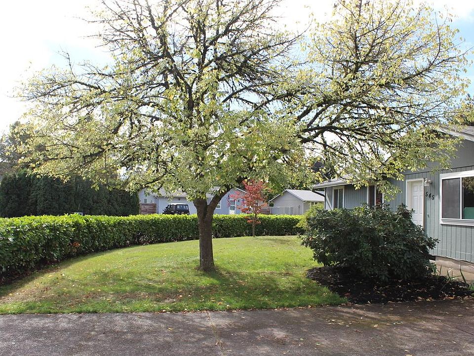 Privacy hedge circles this sunny corner lot