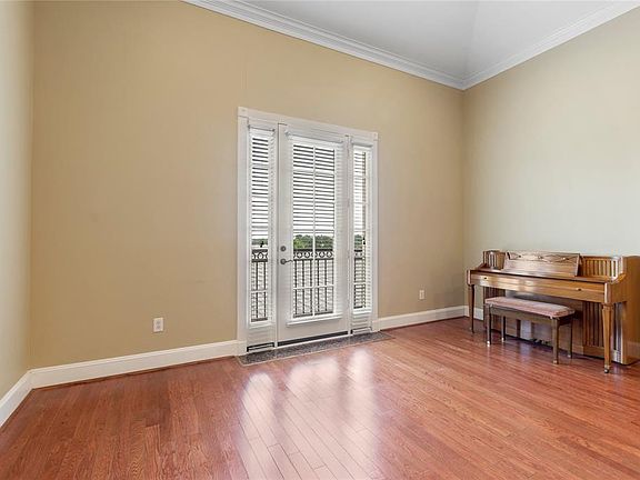 JULIET BALCONY IN THE OPEN FAMILY ROOM. THE CEILINGS ARE TALL AND HAVE CROWN MOLDING.