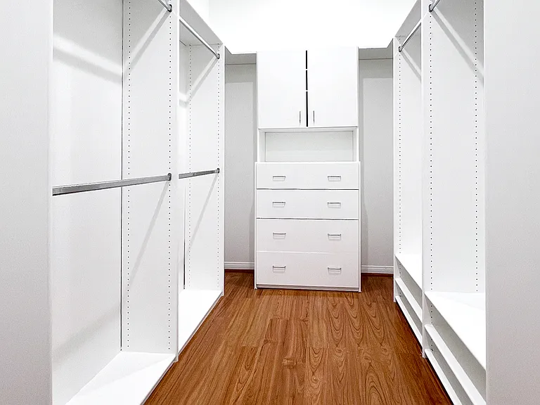Expansive and completely vacant master walk-in closet offering abundant storage space for your wardrobe