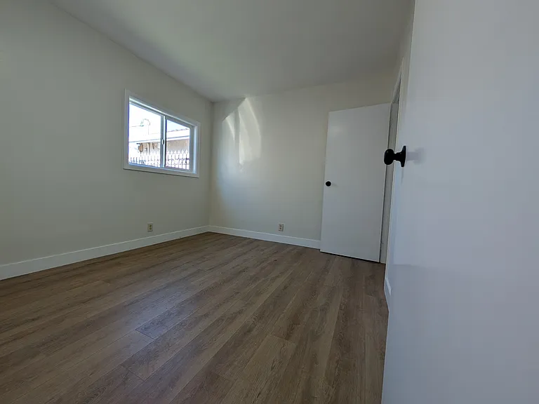 Bedroom one. New Large Window. With closet. Not staged.
