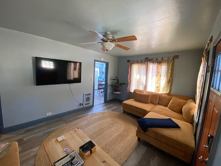 Living room with two couches, coffee table, tv