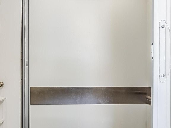 Elevator opens to garage, kitchen, downstairs hallway.