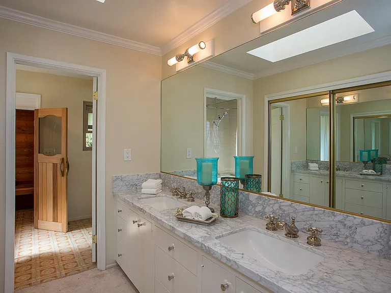 Enjoy a full private bathroom featuring a soaking tub, a separate shower, and the added luxury of a steam sauna for a spa-like experience.