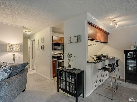 Kitchen with granite counter-tops and tile floor.  Newer appliances stove/range, microwave and dishwasher.  All appliances stay.  Eating bar!