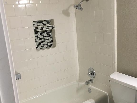 Pretty tiled shower with niche