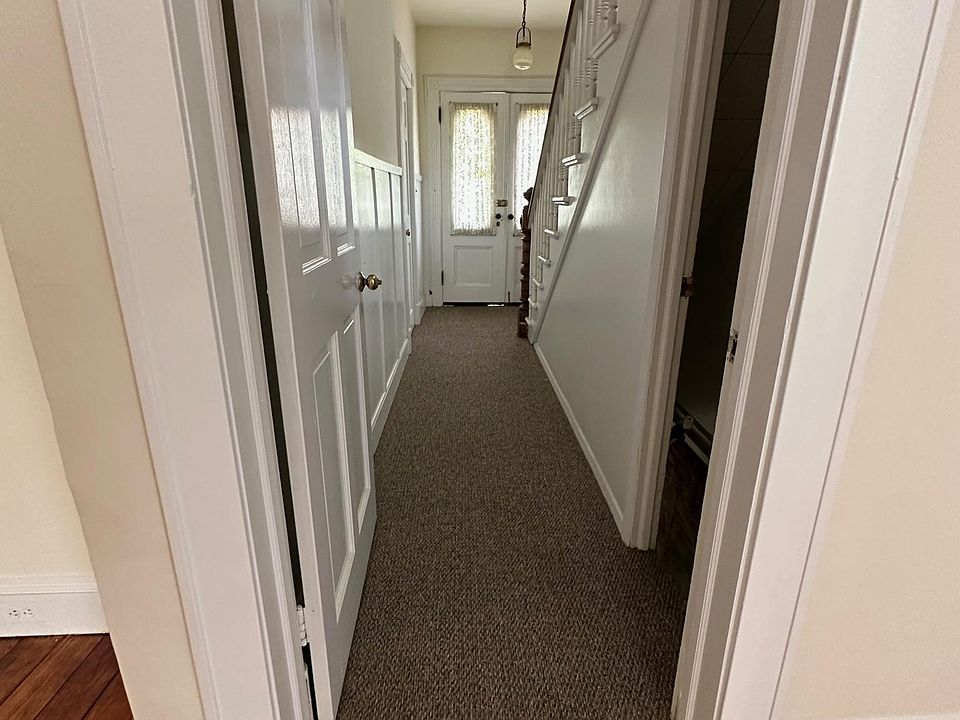 looking from dining room down wntrance hallway to front doors.