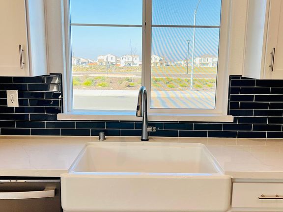 Farm house style kitchen overlooks the park and beautiful sunsets