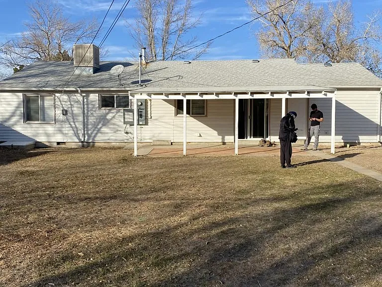 View across the large backyard toward the covered patio in winter