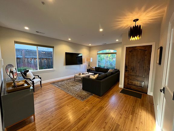 Family room with 60" Smart T and new sectional sofa - opens to Kitchen/dining room for spacious open floor plan