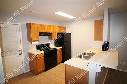 The kitchen is equipped wih a refrigerator, range, dishwasher, and garbage disposer.