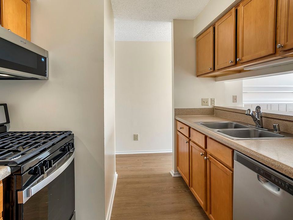 Renovated Package I kitchen with stainless steel appliances, laminate countertops, oak cabinetry, and hard surface flooring