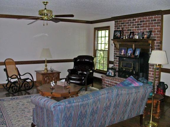 living room with masonry fireplace
