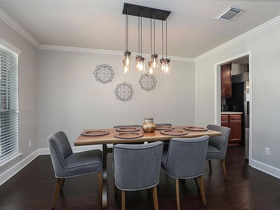 Dining Room with updated light fixture and 2" blinds.  Very light and bright.