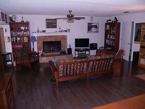 Commericial hardwood flooring and tile fireplace in living area
