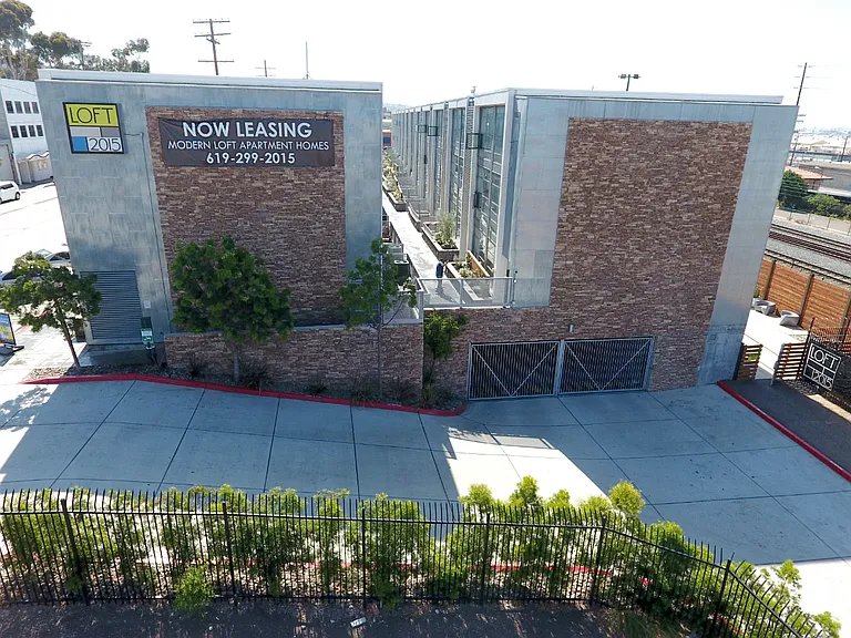 Aerial view of property showing driveway to parking garage