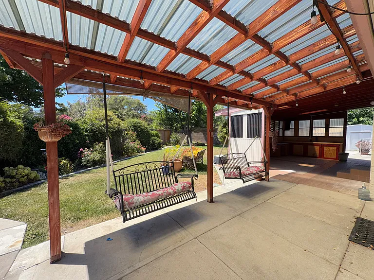 Backyard has both a covered pergola and a separate gazebo for entertaining