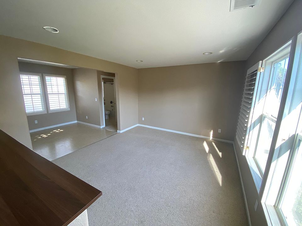 main living room, large windows with morning sun