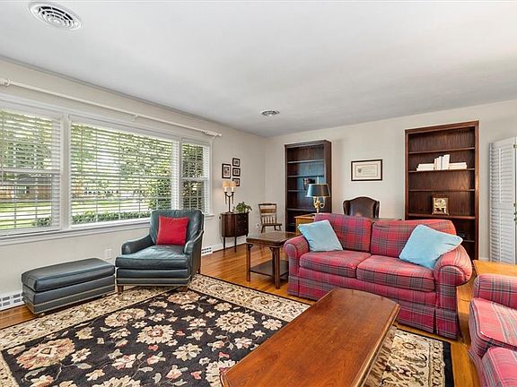 Spacious Living Room with Hardwood Floors and Oversized Windows