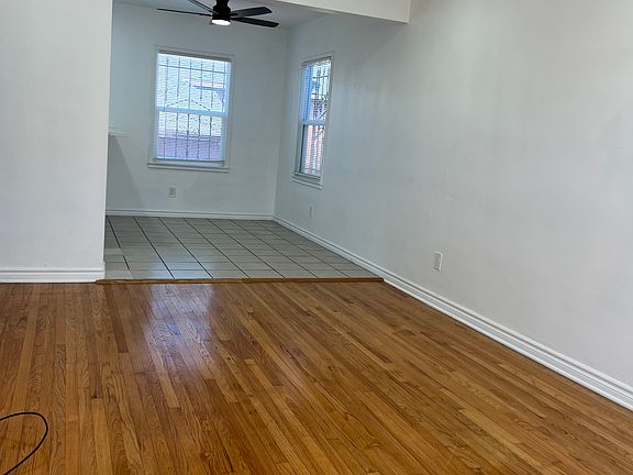 Spacious open living room featuring abundant natural light, recessed lighting, and a bright, airy layout ideal for relaxing or entertaining.
