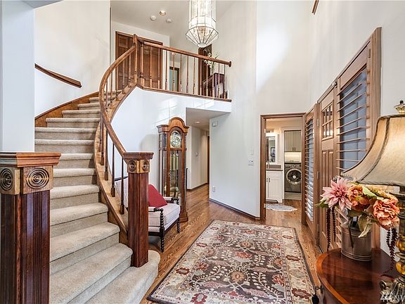 Vaulted ceiling entry with curved staircase and beautiful wood details