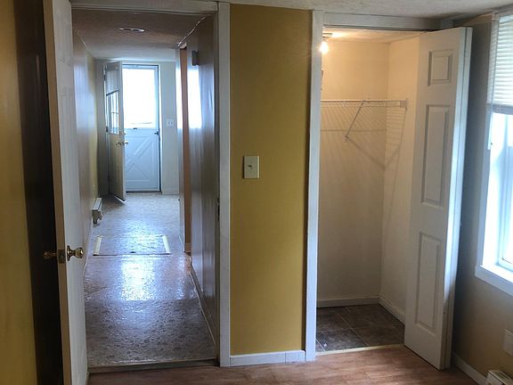 Bedroom with closet. View down the length of the apartment