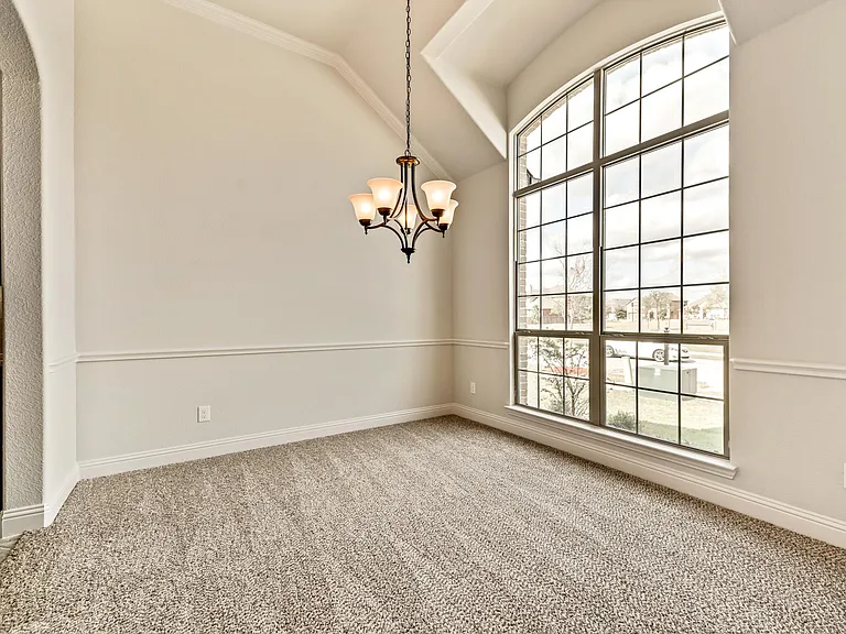 Formal dining/study room is very bright with high ceiling and expansive window