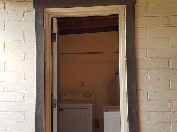 Private laundry room with full size washer and dryer and extra storage.