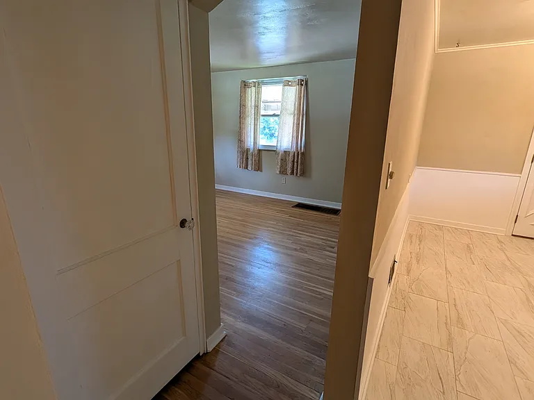 view into living room and kitchen from bathroom doorway
