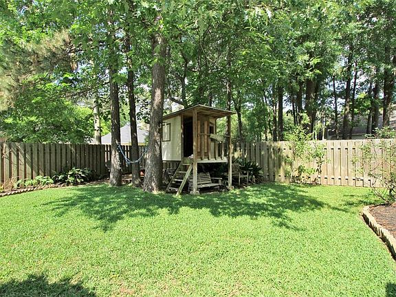 Beautiful Back Yard with large shade trees and a lush lawn.