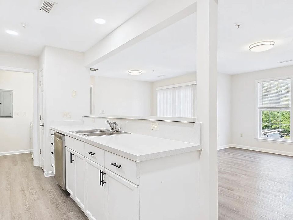 Kitchen and living area filled with bright, natural light that makes it feel open and cheerful.